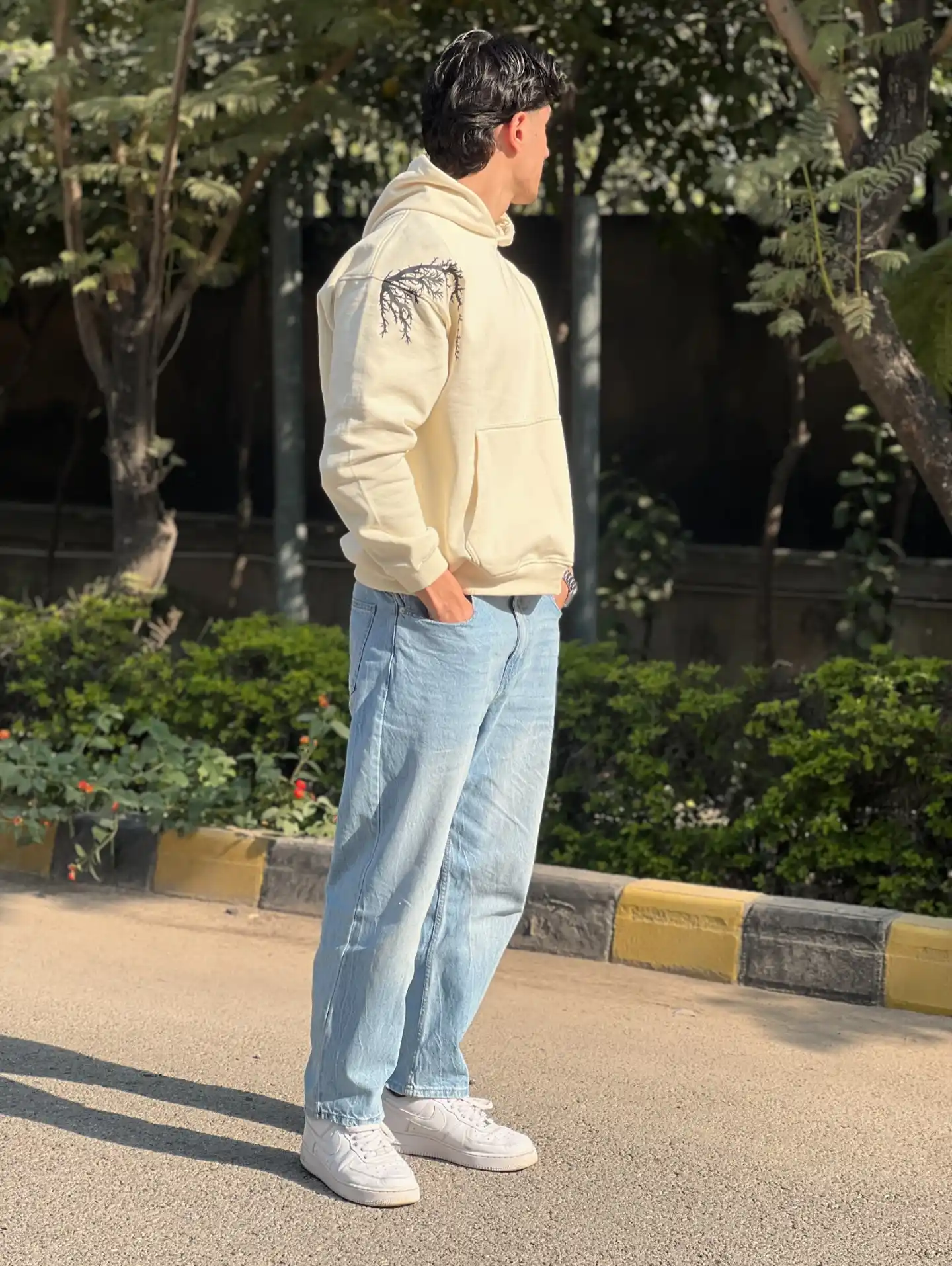 10 Men’s Country & Cabin Trip Outfit Ideas (Casual & Cozy) 2 1. Cream Hoodie with Branch Detail and Light Jeans