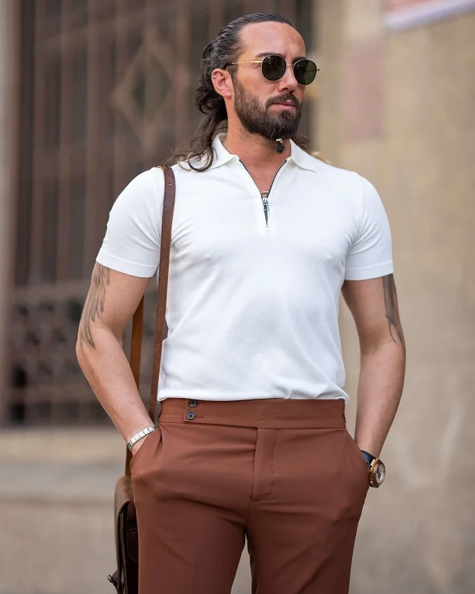 16 Airport Outfit Ideas for Men Over 40 Looks That Feel Age-Appropriate 6 Cream Knit Polo With Rust Trousers for an Easy Color Story
