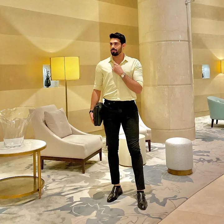 Half Tucking a Pale Shirt Into Black Trousers for Height That Reads Elegant
