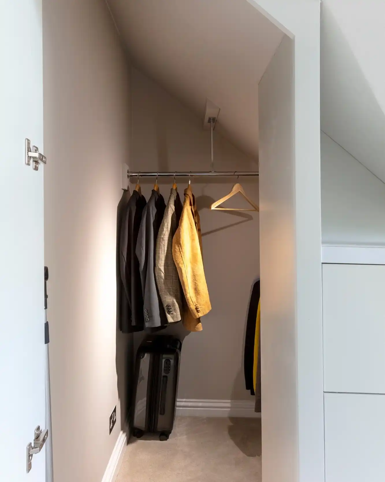 13 Minimalist Men’s Wardrobe Layouts for Small Closets 10 9. Under-Stairs Concealed Closet