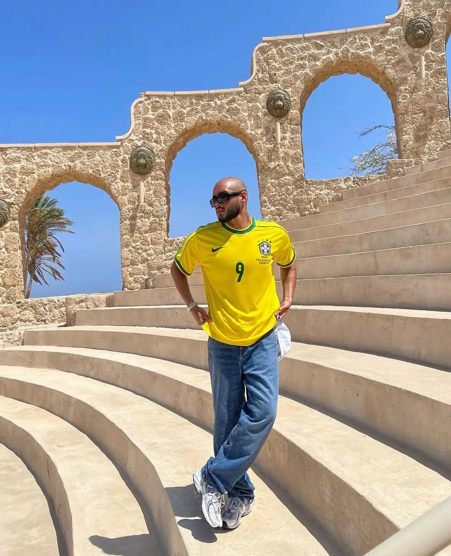 13. Vintage Brazil Yellow Jersey With Baggy Blue Denim and Chunky Sneakers