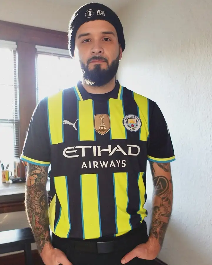 Loud Striped Away Kit Tucked Into Black Trousers