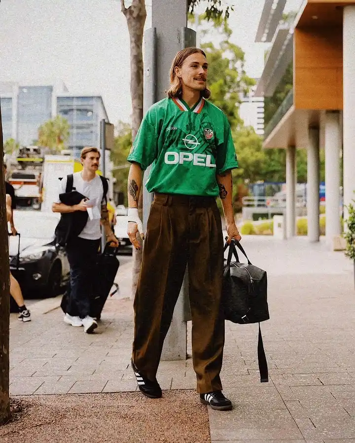 17 Soccer Jersey Streetwear Outfit Ideas for Men 10 Retro Ireland Shirt with Pleated Trousers
