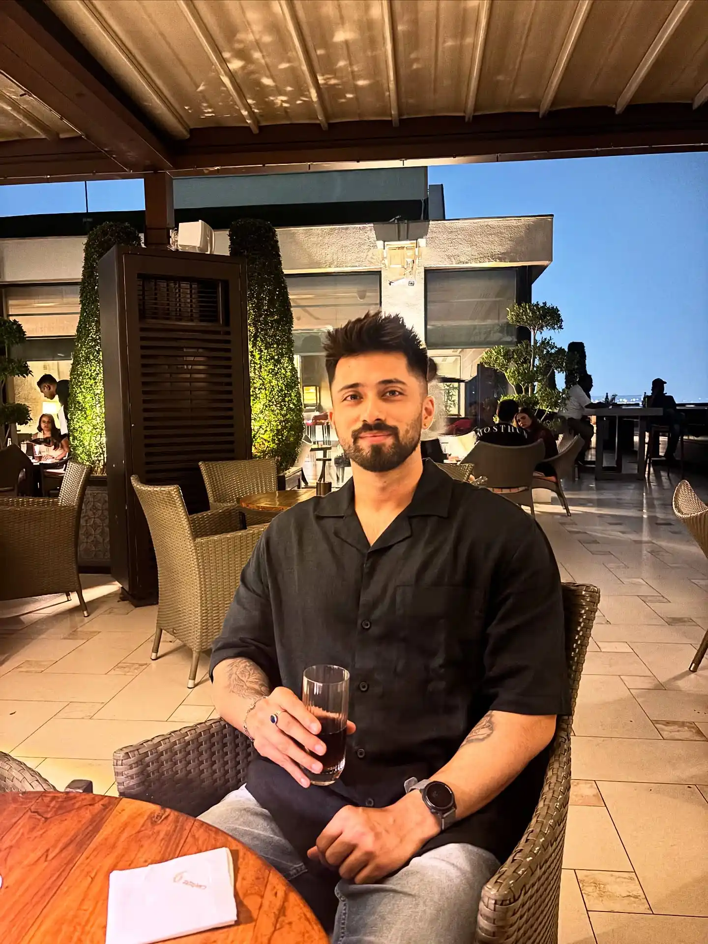 17 Resort‑Ready Men’s Outfits for Tropical Vacations 18 17. Black Cuban Collar Shirt and Grey Jeans