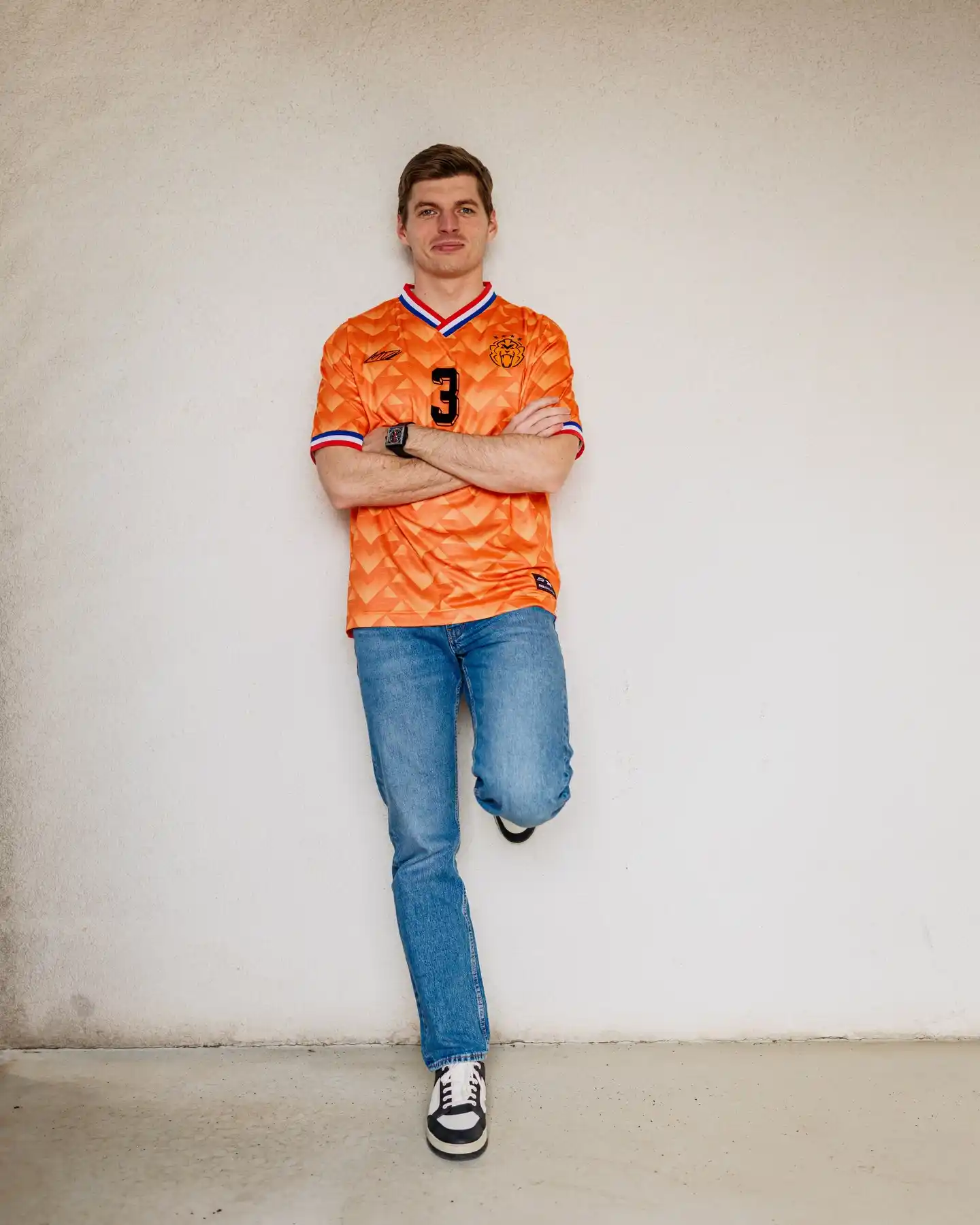 6. Retro Orange Soccer Jersey With Blue Jeans and High-Top Sneakers