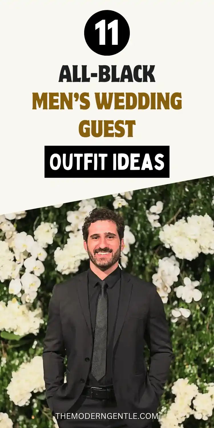 A Pinterest pin reading All-Black Men's Wedding Guest Outfit Ideas, with a black 11 badge on a cream background above a photo of a smiling bearded man standing in front of a wall of white flowers. He wears a black suit jacket over a black button up shirt, a black tie, and a black leather belt, hands tucked into his pockets, showing a monochrome black suit outfit for men against a floral wedding backdrop.