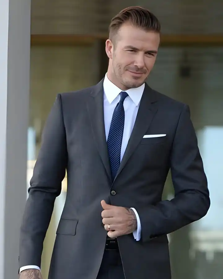 15 Winter Wedding Guest Outfit Ideas for Men 17 15. Charcoal Suit with Striped Navy Tie