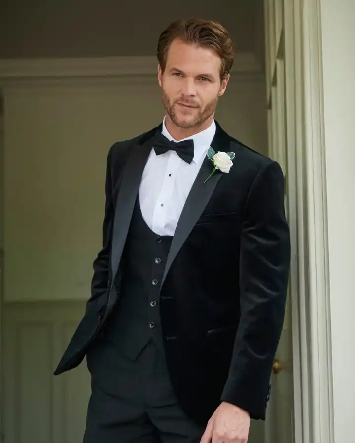 15 Winter Wedding Guest Outfit Ideas for Men 5 3. Black Velvet Tuxedo with Waistcoat