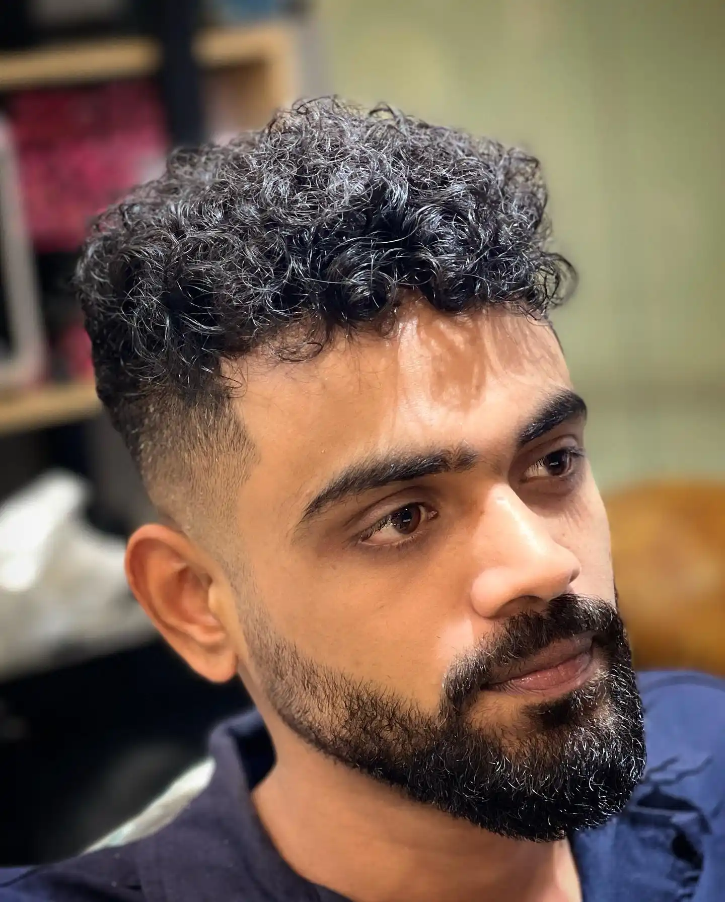3. Mid Fade Curly Hair Men Look With a Full Beard to Balance It Out