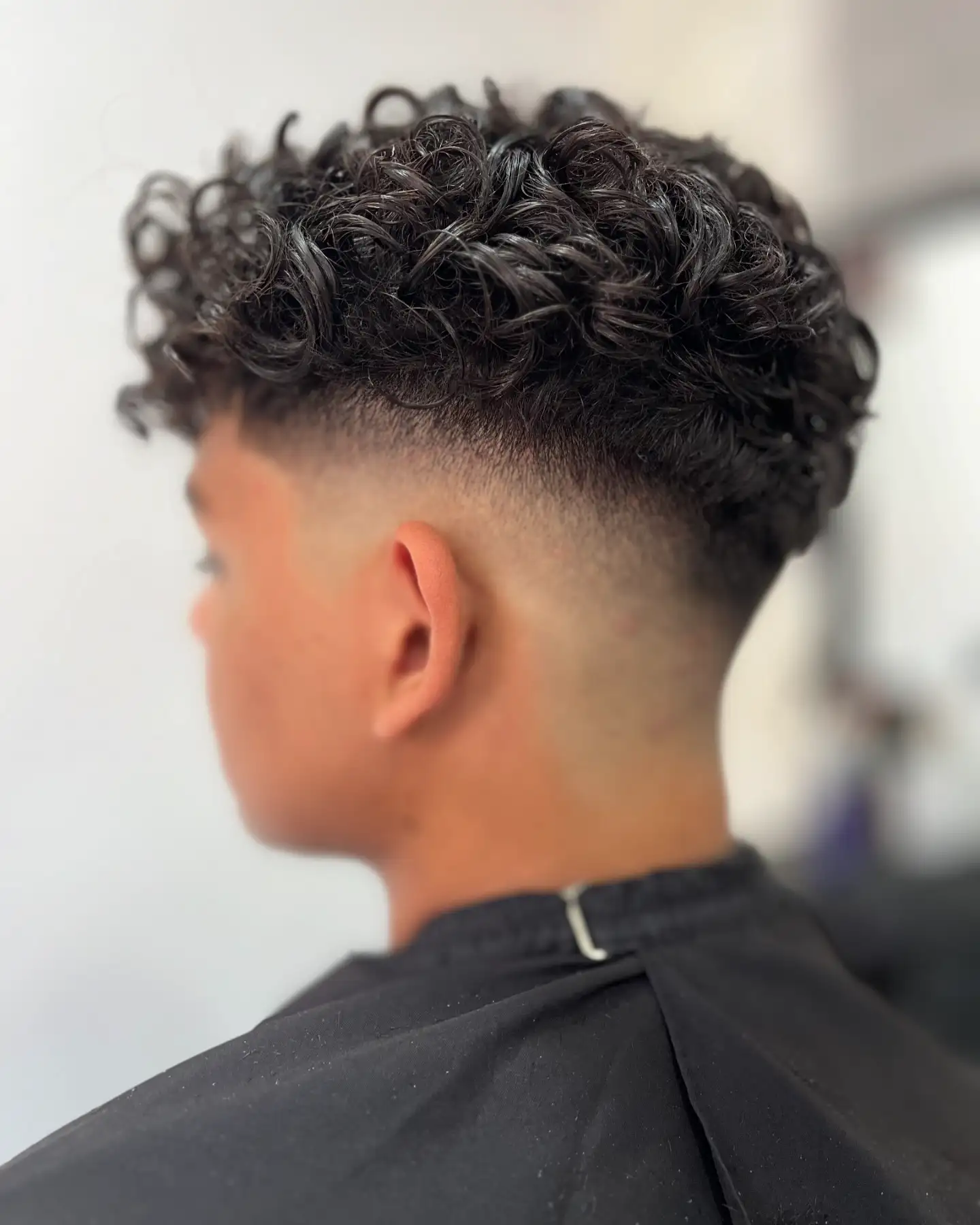 6. The Deep Neckline Fade That Makes Curls Look Like They're Floating