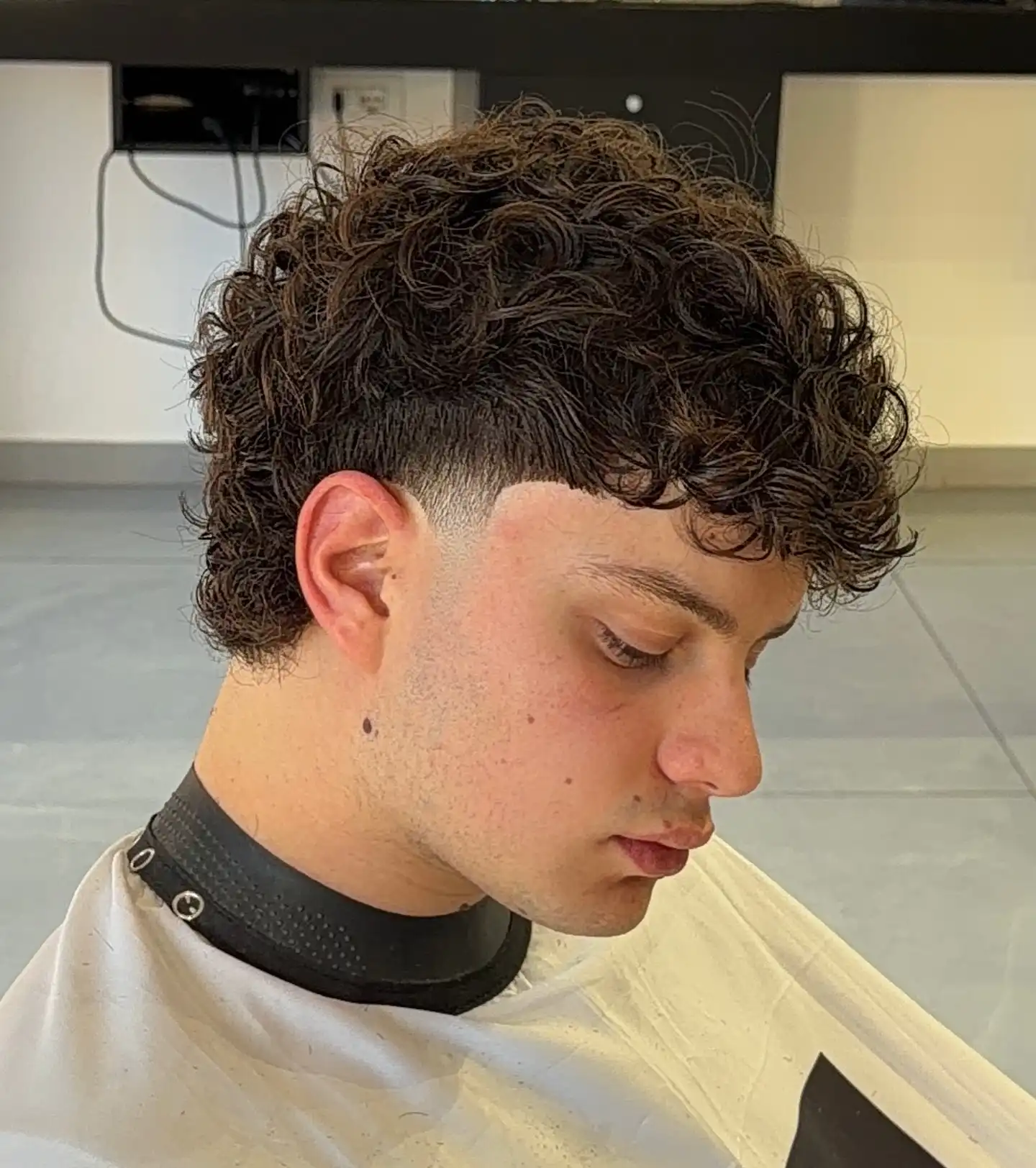 14. Wet Look Curls with Mid Fade