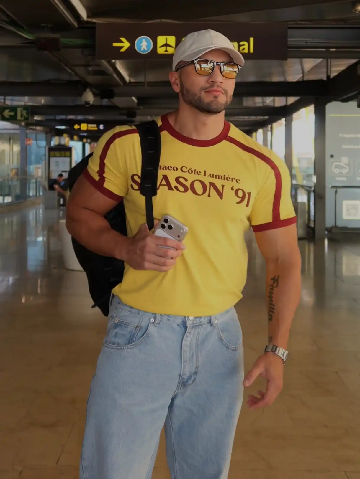 16 Airport Outfit Men Streetwear Looks for Travel Days 17 5. Yellow Ringer Tee with Light Wash Jeans