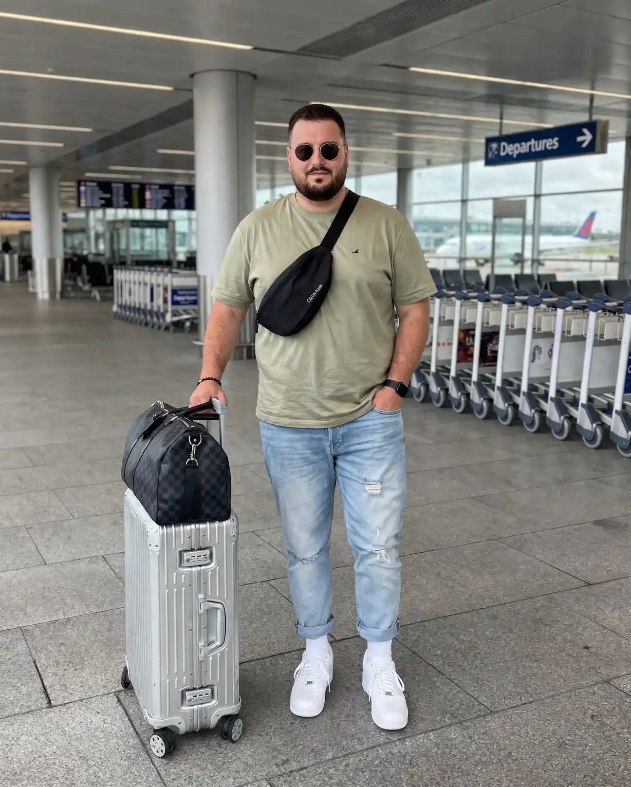 24 Travel Outfit Ideas for Plus Size Men Worth Saving Right Now 5 2. Airport Ready Tee and Cuffed Jeans