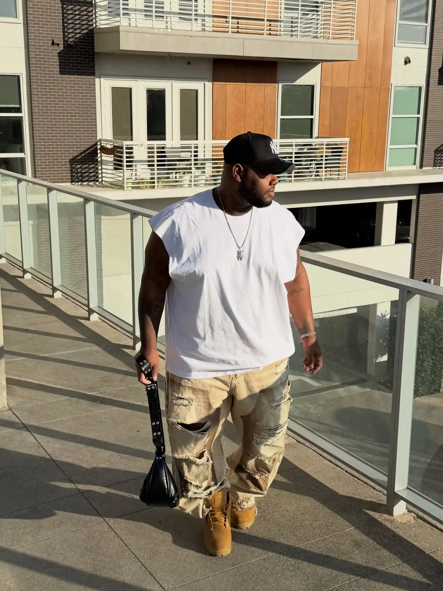 14 Streetwear Outfits for Plus Size Men Real Men Swear By 10 8. Sleeveless Tee With Distressed Cargo Pants