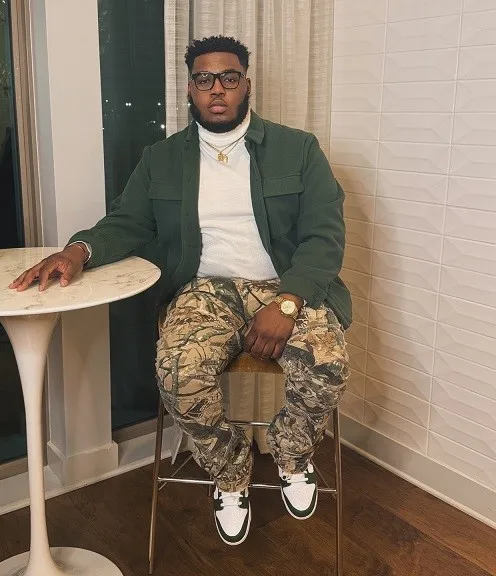 24 Travel Outfit Ideas for Plus Size Men Worth Saving Right Now 11 Green Shirt Jacket Over a White Turtleneck for a City Night Out