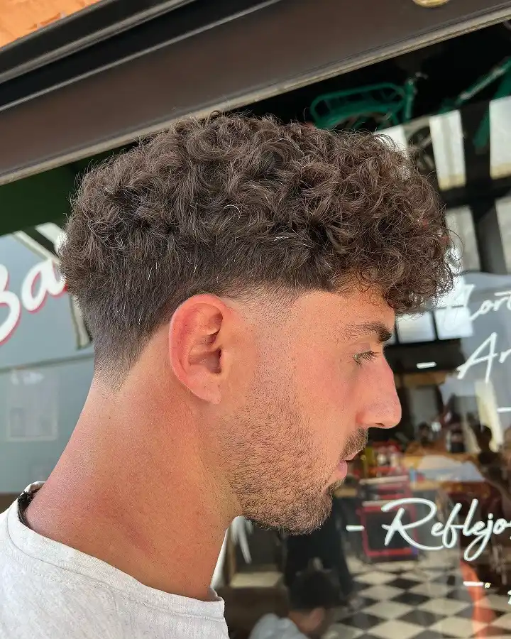 Short Curly Hair for Men: 23 Low-Effort Styles 9 Bulky Curl Bangs Over a Barely Visible Taper