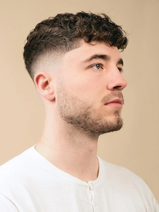 Short Curly Hair for Men: 23 Low-Effort Styles 13 Editorial Curl Crop With a Clean Mid Fade