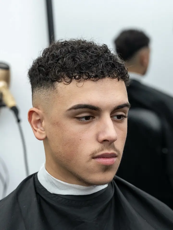 Short Curly Hair for Men: 23 Low-Effort Styles 10 Short, Rounded Fringe With a High Skin Fade