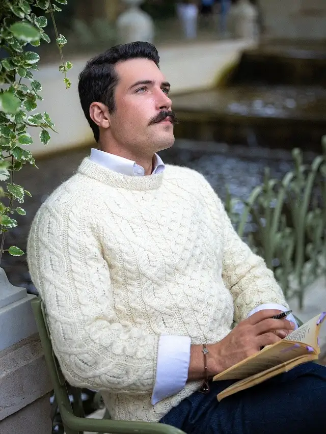 Cream Cable Knit Sweater Over a Crisp White Shirt