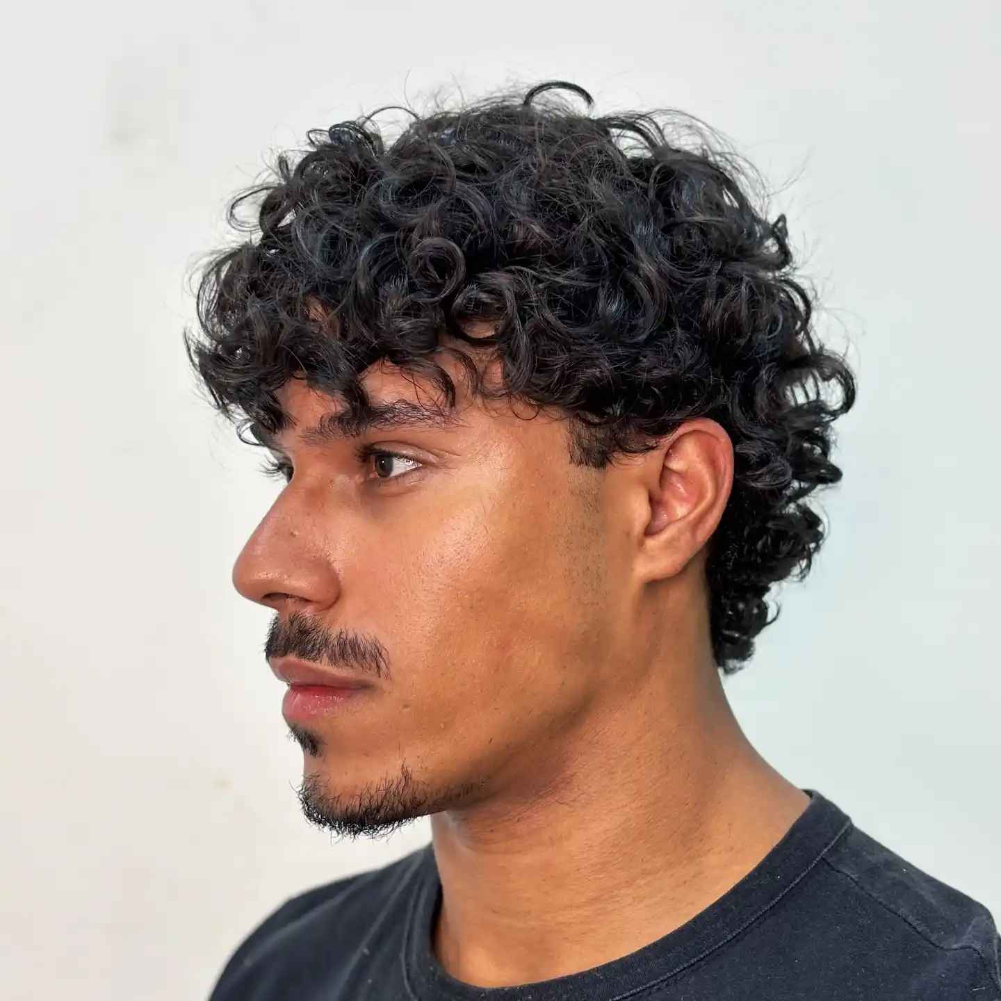 15. Curly Fringe With Thin Mustache