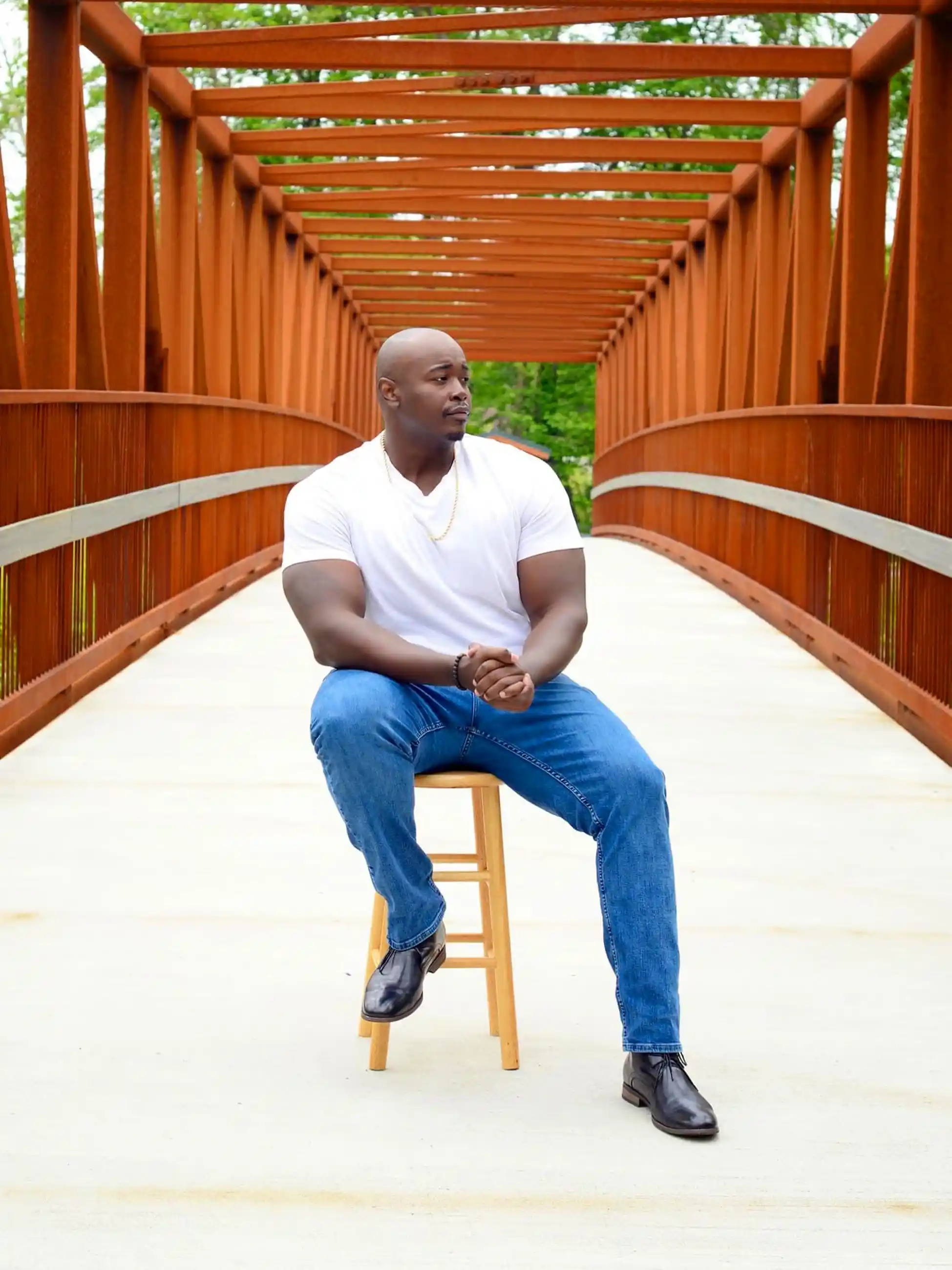 15 Effortless Outfit Ideas for Plus Size Men Real Men Swear By 9 8. White V Neck Tee, Mid Blue Jeans and Dark Leather Boots with a Gold Chain