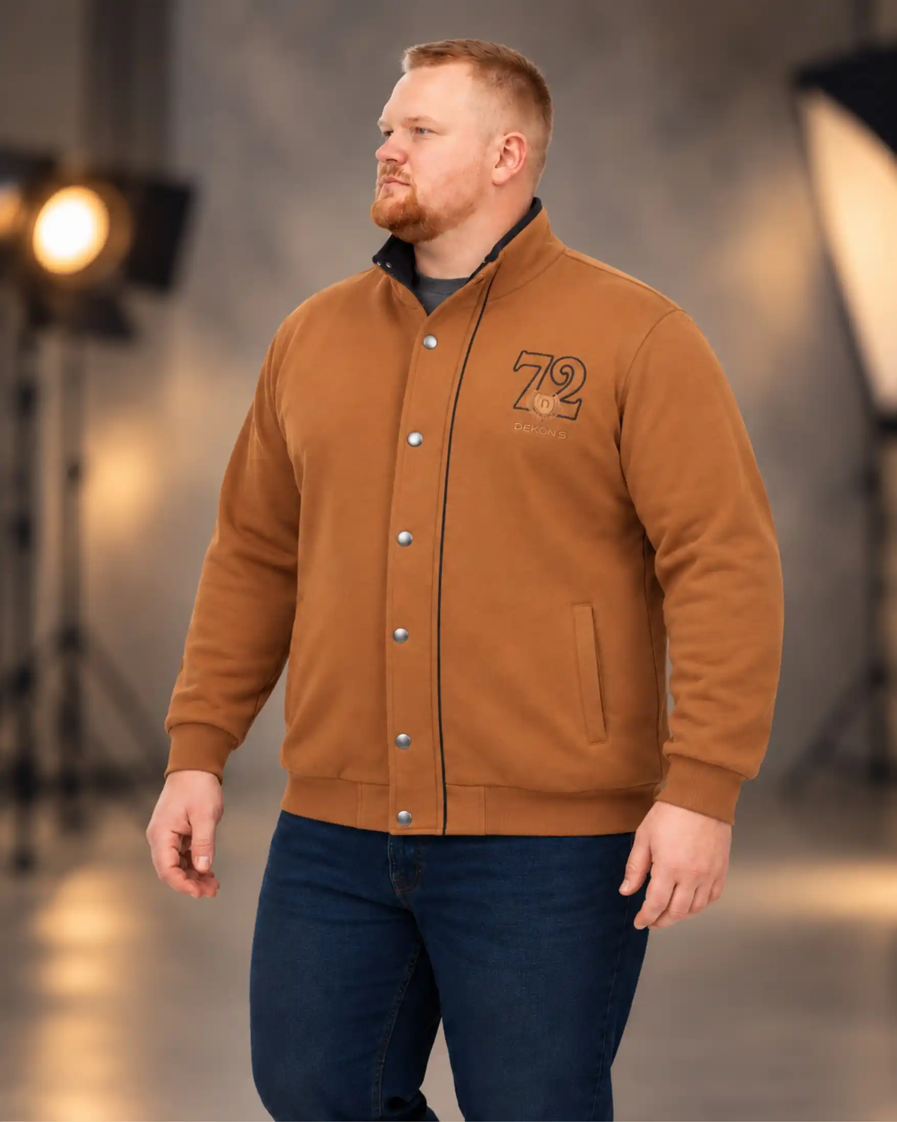 18 Earth Tone Outfits for Plus Size Men You Need to Try 12 12. Caramel Varsity Jacket with Dark Indigo Jeans
