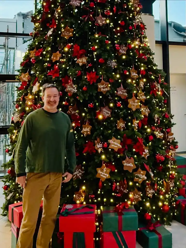 15 Christmas Party Outfits for Plus Size Men That Actually Work 4 Forest Green Long Sleeve Top With Camel Trousers